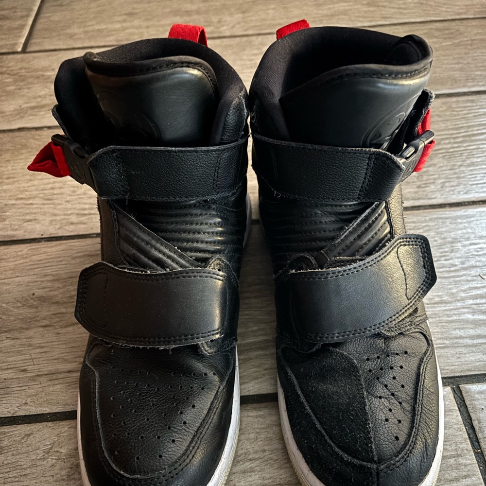Nike Air Jordan 1 Moto riding sneakers with red accents.
